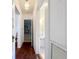 Hallway with hardwood floors leads to bathroom, showing charming details at 1109 Edmonds St, Leesburg, FL 34748