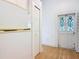 Kitchen area with stainless steel refrigerator, door and hardwood floors at 1109 Edmonds St, Leesburg, FL 34748