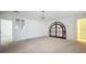 Spacious living room with carpet flooring, built-in cabinet, and unique arched feature at 1109 Edmonds St, Leesburg, FL 34748