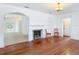 Living room features hardwood floors, fireplace, and archways that bring a touch of character at 1109 Edmonds St, Leesburg, FL 34748