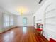 Bright and airy living room features hardwood floors, fireplace, and an arched doorway at 1109 Edmonds St, Leesburg, FL 34748