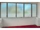 Bright sun room featuring jalousie windows and painted concrete block base at 1109 Edmonds St, Leesburg, FL 34748