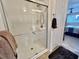 Recently renovated glass enclosed shower with convenient towel rack provides a spa-like experience at 117 Jacaranda Dr, Leesburg, FL 34748