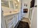 Bathroom features a decorative vanity with drawers and cabinets, plus a glass-enclosed shower for easy access at 117 Jacaranda Dr, Leesburg, FL 34748