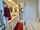 Bright bathroom featuring a single sink vanity, a large mirror, and a walk-in shower at 117 Jacaranda Dr, Leesburg, FL 34748
