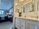 Bright bathroom features a decorative vanity and a stylish mirror with easy access to the main bedroom at 117 Jacaranda Dr, Leesburg, FL 34748