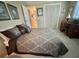 Well-lit bedroom with a spacious closet, decorative pillows, and a cozy desk area at 117 Jacaranda Dr, Leesburg, FL 34748