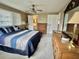 Bright bedroom featuring wood furniture, a ceiling fan, and access to a bathroom and closet at 117 Jacaranda Dr, Leesburg, FL 34748