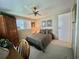 Comfortable bedroom with soft carpet, a ceiling fan, and a large bed with decorative pillows at 117 Jacaranda Dr, Leesburg, FL 34748