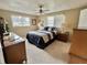 Relaxing bedroom with two large windows providing plenty of natural light and stylish furnishings at 117 Jacaranda Dr, Leesburg, FL 34748