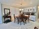 Dining area featuring a wood table, built-in cabinetry, large windows, and classic design elements at 117 Jacaranda Dr, Leesburg, FL 34748