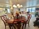 Cozy dining area with a round wooden table, seating for four, and an open view to the living room at 117 Jacaranda Dr, Leesburg, FL 34748