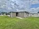 Exterior shot of the home showcasing its clean lines and lawn at 117 Jacaranda Dr, Leesburg, FL 34748