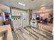 Open kitchen layout with bar seating, adjacent living and dining spaces at 117 Jacaranda Dr, Leesburg, FL 34748