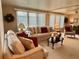Inviting living room with neutral furniture, decorative pillows, and abundant natural light from large windows at 117 Jacaranda Dr, Leesburg, FL 34748