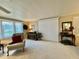 Comfortable living room featuring bright windows and a ceiling fan at 117 Jacaranda Dr, Leesburg, FL 34748