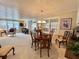 Spacious living and dining space with wood table, comfortable seating, and sliding door to lanai at 117 Jacaranda Dr, Leesburg, FL 34748