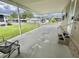 Covered patio view showcasing community homes and landscaping at 117 Jacaranda Dr, Leesburg, FL 34748