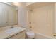 Bathroom featuring white vanity, white toilet, framed mirror, and tub/shower combo at 12 Windtree Ln # 202, Winter Garden, FL 34787