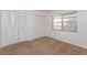 Bedroom featuring neutral carpet, a window for natural light, and dual closets at 12 Windtree Ln # 202, Winter Garden, FL 34787