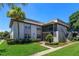 Well-maintained condo with lush landscaping, mature palm trees, and inviting screened in porch at 12 Windtree Ln # 202, Winter Garden, FL 34787