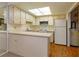 Bright kitchen featuring white cabinets, countertops, skylight and modern appliances at 12 Windtree Ln # 202, Winter Garden, FL 34787