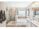 Bright bathroom showcasing shower, bath, double sinks and vanity at 12120 Sumter Dr, Orlando, FL 32824