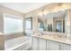 This bright bathroom features double sinks, bath, and tile surround at 12120 Sumter Dr, Orlando, FL 32824
