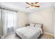 This cozy bedroom features a comfy bed, light-colored walls, and a ceiling fan at 12120 Sumter Dr, Orlando, FL 32824
