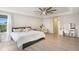 Large, bright bedroom with wood floors, tray ceiling, furniture, and ensuite bathroom at 12120 Sumter Dr, Orlando, FL 32824