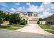 Charming two-story home with a well-manicured lawn and a spacious driveway at 12120 Sumter Dr, Orlando, FL 32824