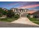 Charming two-story home featuring a well-maintained lawn and a long driveway leading to an attached garage at 12120 Sumter Dr, Orlando, FL 32824