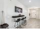 Close up view of the game room bar featuring modern stools, stylish decor, and pool cues at 12120 Sumter Dr, Orlando, FL 32824