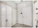 Hallway features a white door, built-in storage cabinet, and neutral wall color, offering clean and functional design at 12120 Sumter Dr, Orlando, FL 32824