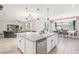 Bright kitchen features a large island with granite countertops, stainless steel appliances, and an open layout at 12120 Sumter Dr, Orlando, FL 32824