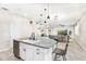 Open kitchen with island seating and an adjacent living room at 12120 Sumter Dr, Orlando, FL 32824