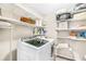 This functional laundry room boasts ample shelving space, and front load washer and dryer at 12120 Sumter Dr, Orlando, FL 32824