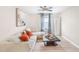 Comfortable living room with a modern sofa, accent pillows, stylish coffee table, and a large window at 12120 Sumter Dr, Orlando, FL 32824