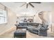 Living room with gray sectional sofa, open to the kitchen and staircase at 12120 Sumter Dr, Orlando, FL 32824