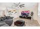 Inviting living room featuring a large TV, stylish ceiling fan, and comfortable seating at 12120 Sumter Dr, Orlando, FL 32824