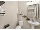 Stylish powder room featuring a pedestal sink, modern mirror, and decorative shelving at 12120 Sumter Dr, Orlando, FL 32824
