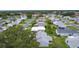 An aerial view showcases a neighborhood with diverse houses, green spaces, and tree-lined streets at 1225 Zapata Pl, The Villages, FL 32159