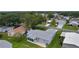A high angle view displays the home, patio, lawn and surrounding neighborhood at 1225 Zapata Pl, The Villages, FL 32159