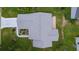 High angle view of a home's roof, landscaping, and driveway, surrounded by green lawns and decorative garden features at 1225 Zapata Pl, The Villages, FL 32159