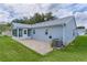 Backyard with a sunroom and brick patio at 1225 Zapata Pl, The Villages, FL 32159