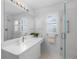 All-white bathroom featuring a glass walk-in shower, quartz counters, and natural light at 1225 Zapata Pl, The Villages, FL 32159