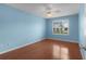 Bedroom featuring a ceiling fan, wood flooring, and a window with white shutters at 1225 Zapata Pl, The Villages, FL 32159