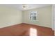 Bedroom featuring a ceiling fan, wood flooring, and a window with white shutters at 1225 Zapata Pl, The Villages, FL 32159