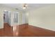 Large bedroom features hardwood floors and en-suite bathroom with glass shower at 1225 Zapata Pl, The Villages, FL 32159