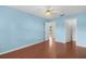 Bedroom featuring a ceiling fan, wood flooring, and access to the bathroom at 1225 Zapata Pl, The Villages, FL 32159
